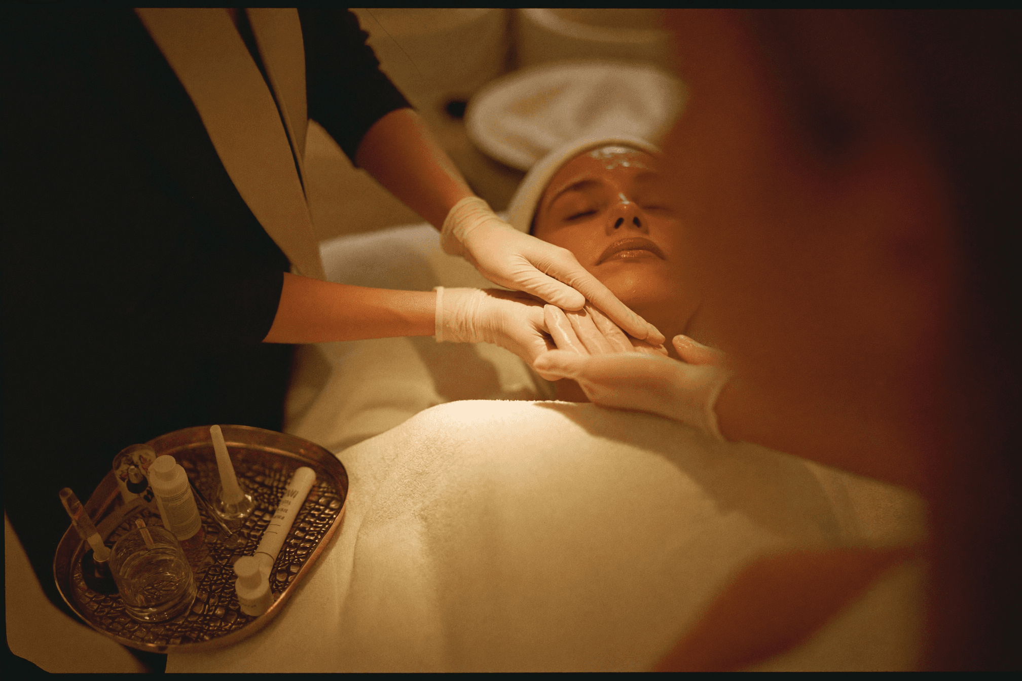 Hands-on aesthetics training at Beauty Zensation — mentor guiding a student during a facial demonstration