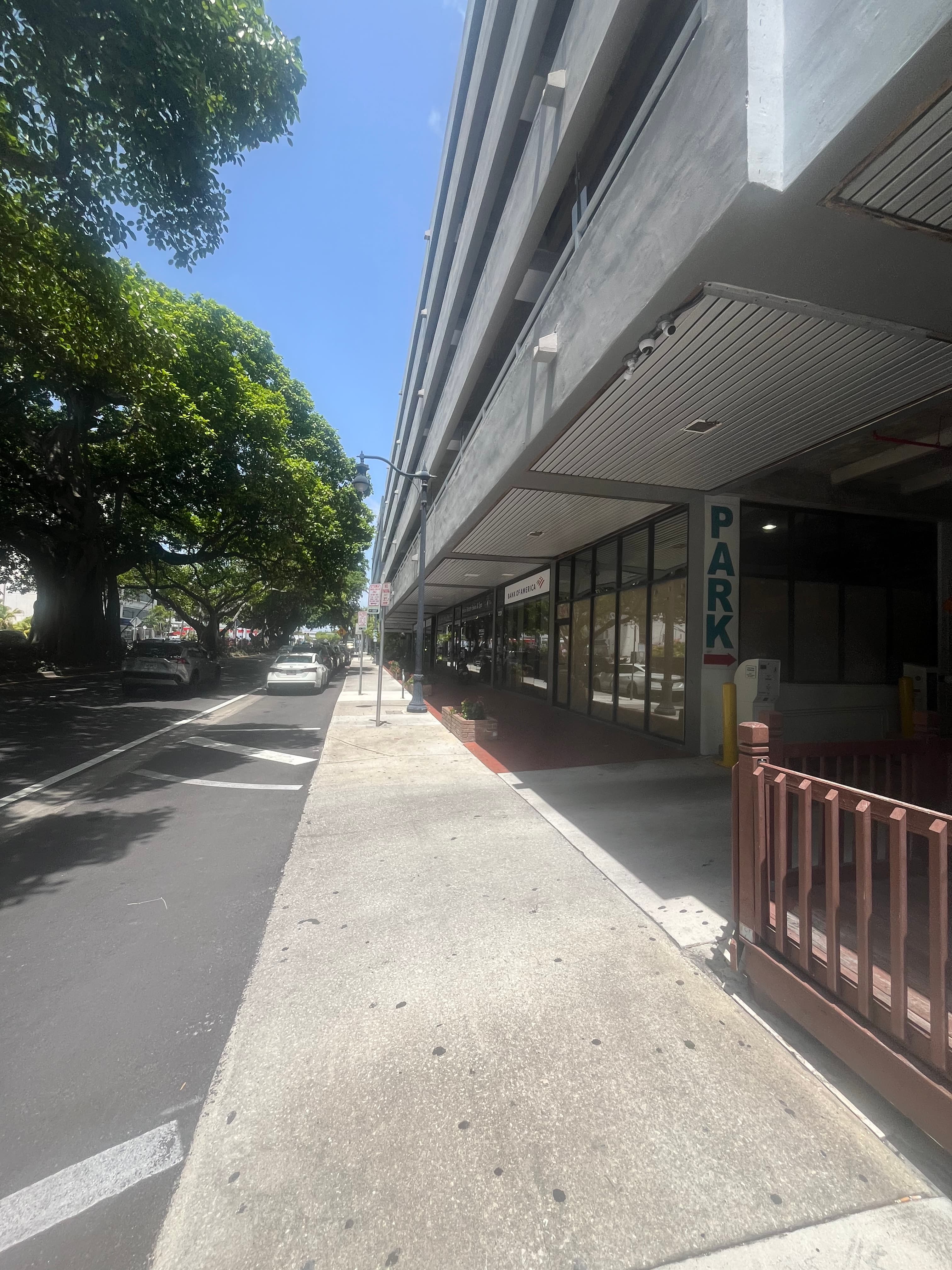 Coral Way sidewalk approaching the parking garage entrance at 2103 Coral Way, Miami