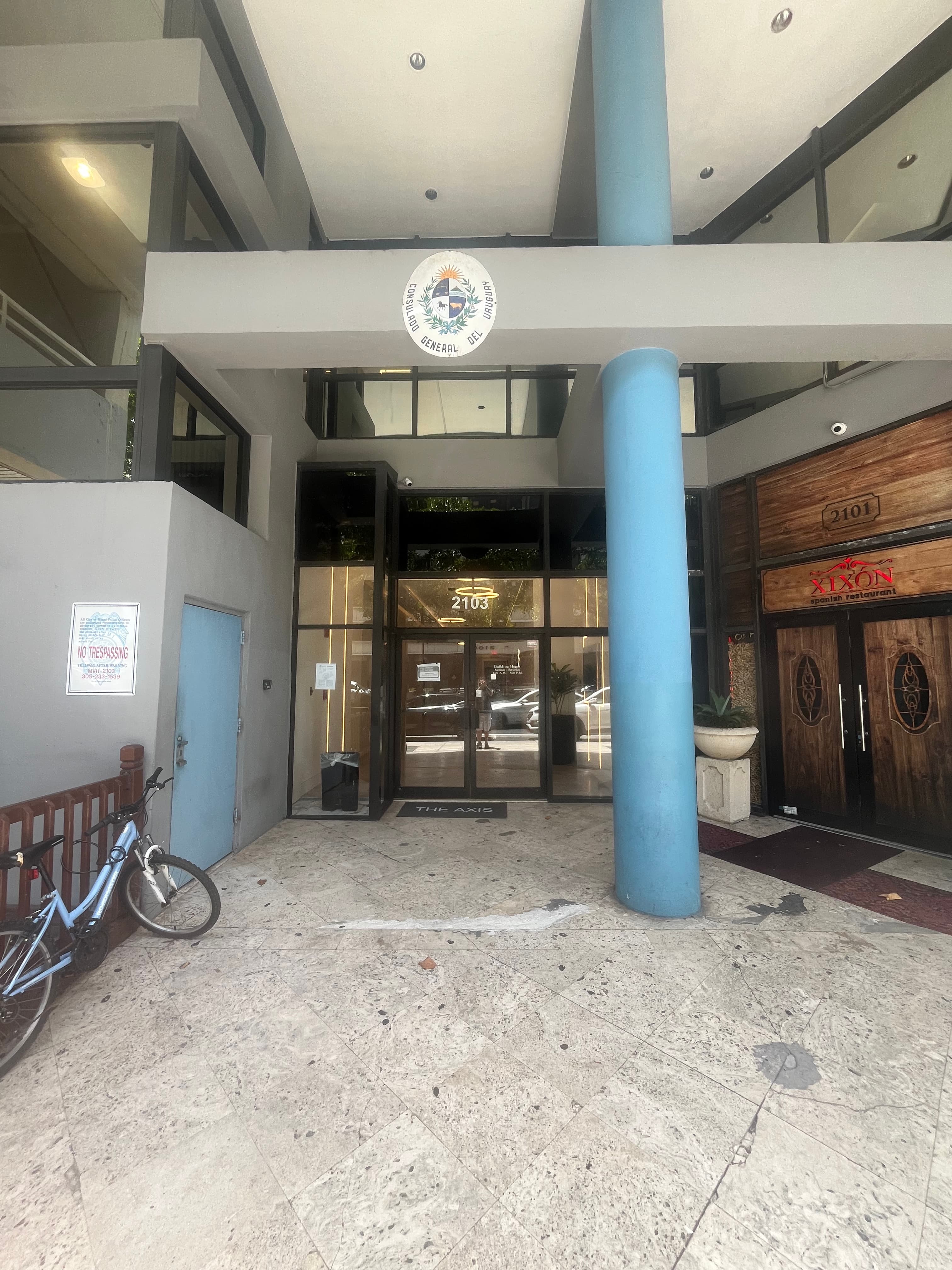 The AXIS building lobby entrance at 2103 Coral Way, next to Xixon Spanish Restaurant